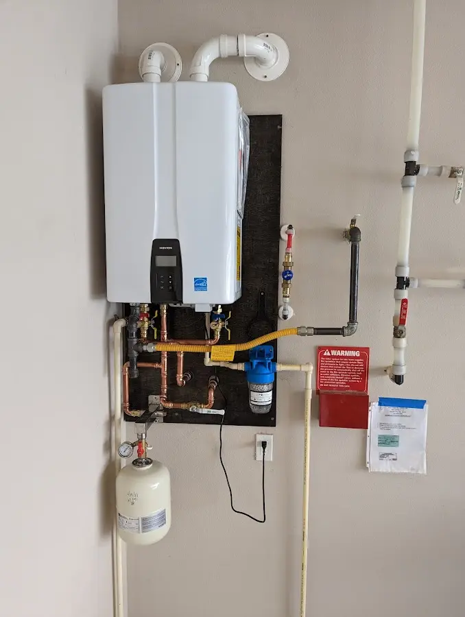 Professional plumber installing copper piping in a Muncy Creek home